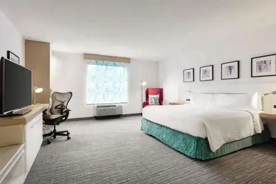 a hotel room with a bed and a flat screen tv at Hilton Garden Inn Bridgewater in Bridgewater