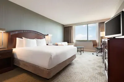 a hotel room with a large bed and a television at Hilton East Brunswick in East Brunswick
