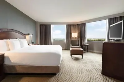 a hotel room with a bed and a television at Hilton East Brunswick in East Brunswick