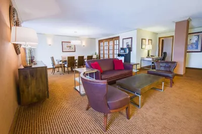 a living room with a couch and chairs and a table at DoubleTree by Hilton Philadelphia Airport in Philadelphia