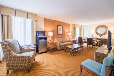 a living room with a couch and chairs and a table at DoubleTree by Hilton Philadelphia Airport in Philadelphia