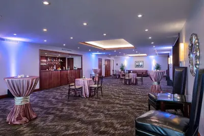 a banquet room with tables and chairs and a bar at DoubleTree by Hilton Philadelphia Airport in Philadelphia