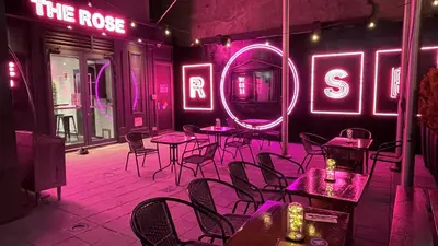 a restaurant with tables and chairs and neon signs at The Chelsean New York in New York