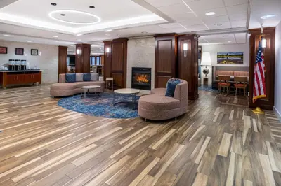 a lobby with two chairs and a fireplace at Hampton Inn Harriman Woodbury in Central Valley