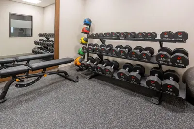 a gym with a rack of dumbbells and shoes at Hampton Inn Harriman Woodbury in Central Valley