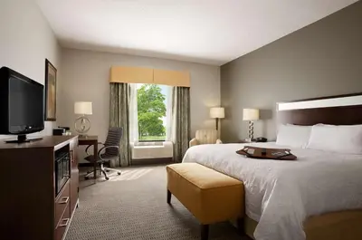 a hotel room with a bed and a television at Hampton Inn & Suites - Mansfield in Mansfield
