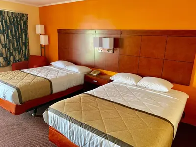 a hotel room with two beds in a room at Budget Inn Mifflintown in Mifflintown