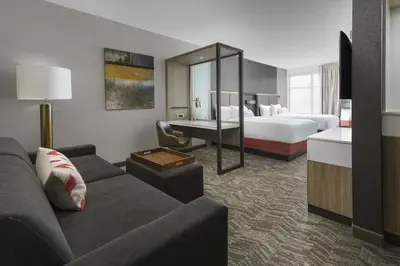 a hotel room with a couch and a bed and a desk at SpringHill Suites by Marriott Philadelphia West Chester/Exton in Exton
