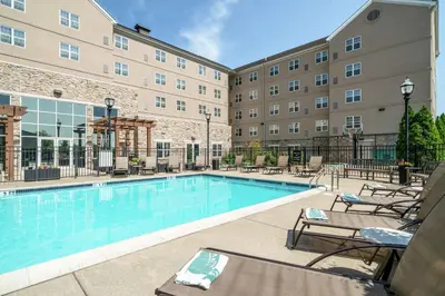 a swimming pool with lounge chairs and a hotel at Homewood Suites by Hilton Philadelphia-Valley Forge in Audubon
