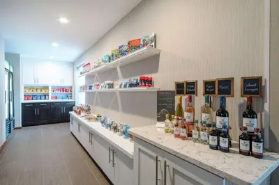 a room with a counter with bottles of wine at Homewood Suites by Hilton Philadelphia-Valley Forge in Audubon
