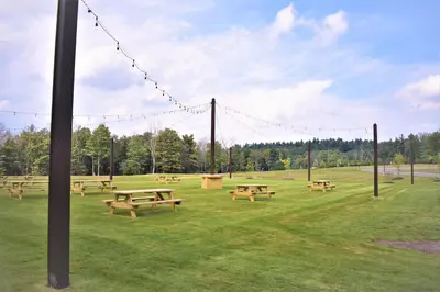a group of picnic tables in a field at The Alder in Monticello