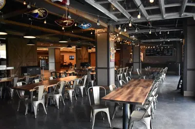 a dining room with wooden tables and white chairs at The Alder in Monticello