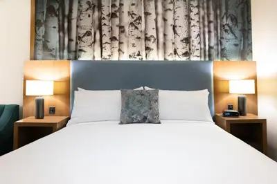 a bedroom with a large bed with two lamps at The Alder in Monticello
