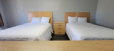 two beds in a hotel room with two at Superlodge in New Castle