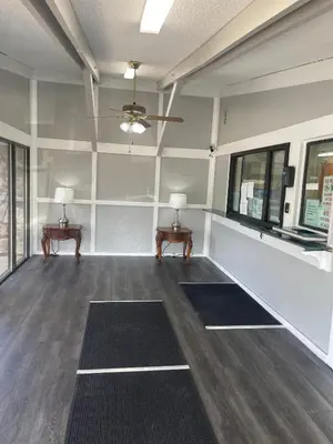 an empty room with two tables and two windows at Superlodge in New Castle