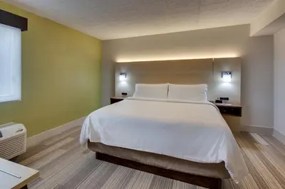 a bedroom with a large bed with white sheets at Holiday Inn Express Pittston - Scranton Airport by IHG in Pittston