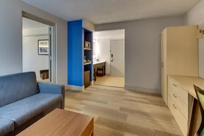 a living room with a couch and a table at Holiday Inn Express Pittston - Scranton Airport by IHG in Pittston