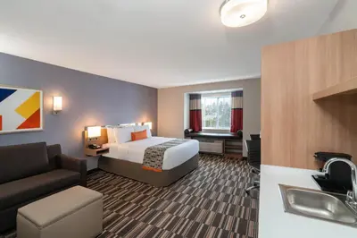 a hotel room with a bed and a sink at Microtel Inn & Suites by Wyndham Carlisle in Carlisle