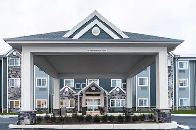 a large blue house with a large garage at Microtel Inn & Suites by Wyndham Carlisle in Carlisle
