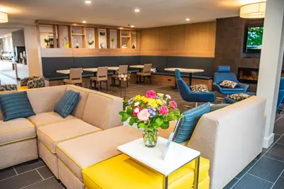 a lobby with couches and a table with a vase of flowers at Microtel Inn & Suites by Wyndham Carlisle in Carlisle