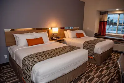 a hotel room with two beds and a window at Microtel Inn & Suites by Wyndham Carlisle in Carlisle