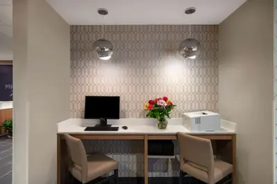 an office with a desk with a computer and two chairs at Microtel Inn & Suites by Wyndham Carlisle in Carlisle