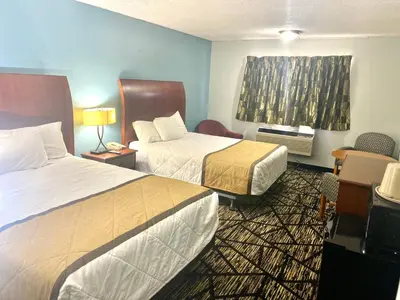 a hotel room with two beds and a window at Knights Inn Paxinos Elysburg in Paxinos