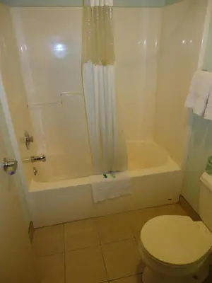 a bathroom with a tub and a toilet and a shower at Knights Inn Paxinos Elysburg in Paxinos