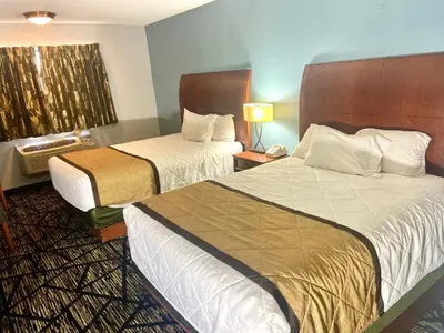 a hotel room with two beds and a window at Knights Inn Paxinos Elysburg in Paxinos