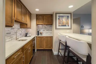 a kitchen with wooden cabinets and white counter tops at Hampton Inn Carlstadt At The Meadowlands in Carlstadt