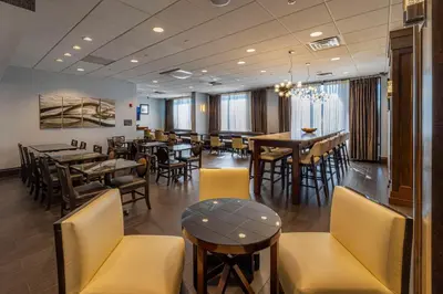 a dining room with tables and chairs in a restaurant at Hampton Inn Carlstadt At The Meadowlands in Carlstadt