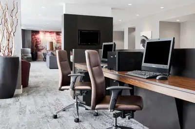 an office with a desk with a computer and chairs at Courtyard by Marriott Newark Downtown in Newark