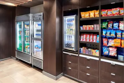 a store aisle with two refrigerators and drinks at Courtyard by Marriott Newark Downtown in Newark