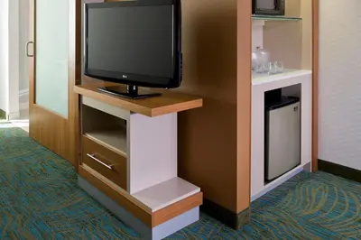 a flat screen tv on a stand in a room at SpringHill Suites by Marriott Philadelphia Langhorne in Langhorne