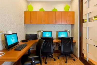 an office with three computers on a desk with chairs at SpringHill Suites by Marriott Philadelphia Langhorne in Langhorne