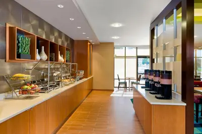a restaurant with a counter with food on it at SpringHill Suites by Marriott Philadelphia Langhorne in Langhorne