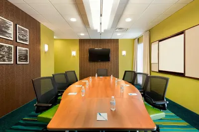a conference room with a large wooden table and chairs at SpringHill Suites by Marriott Philadelphia Langhorne in Langhorne
