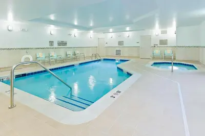 a large indoor pool with blue water in a building at SpringHill Suites by Marriott Philadelphia Langhorne in Langhorne