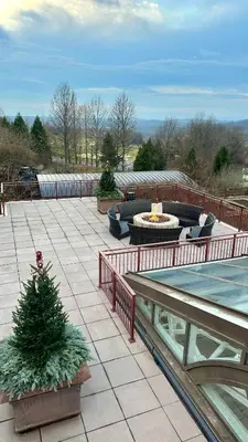 a patio with a christmas tree and a fountain at Ski on Ski off Mtn Chalet in Vernon