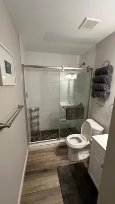 a bathroom with a shower and a toilet and a sink at Ski on Ski off Mtn Chalet in Vernon