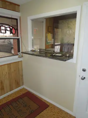 a room with a counter and a door with a window at Slumberland Motel Mount Holly in Mount Holly