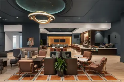 a lobby of a hotel with tables and chairs at Hilton Philadelphia City Avenue in Philadelphia