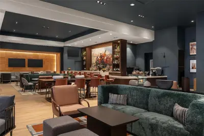 a lobby with a couch and tables and a bar at Hilton Philadelphia City Avenue in Philadelphia