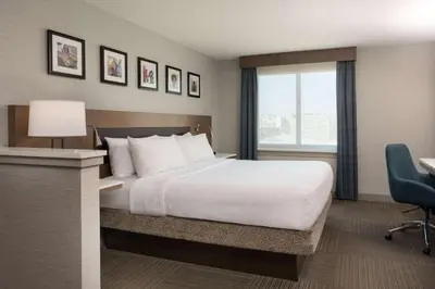 a hotel room with a large bed and a desk at Hilton Garden Inn Philadelphia Center City in Philadelphia