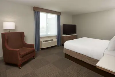 a bedroom with a bed and a chair and a television at Hilton Garden Inn Philadelphia Center City in Philadelphia