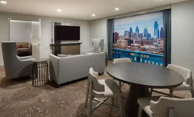 a living room with a view of a city at Hilton Garden Inn Philadelphia Center City in Philadelphia
