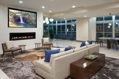 a lobby with a couch and a fireplace at Hilton Garden Inn Philadelphia Center City in Philadelphia