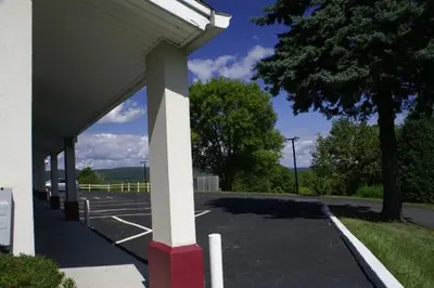 a parking lot with a white and red pole at Appalachian Motel in Vernon