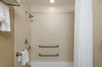 a bathroom with a shower with a tub and a toilet at Holiday Inn Express Princeton Southeast by IHG in Plainsboro