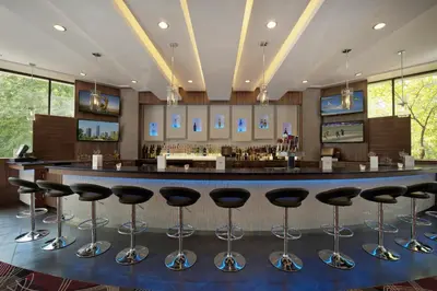 a bar with black stools in a room at Holiday Inn Express Princeton Southeast by IHG in Plainsboro